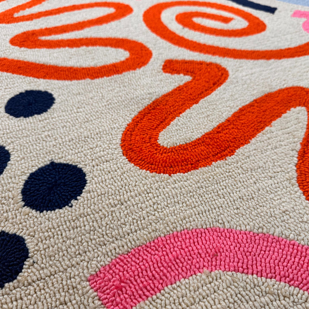 Desert Sand rug close-up highlighting vibrant abstract patterns and soft texture.