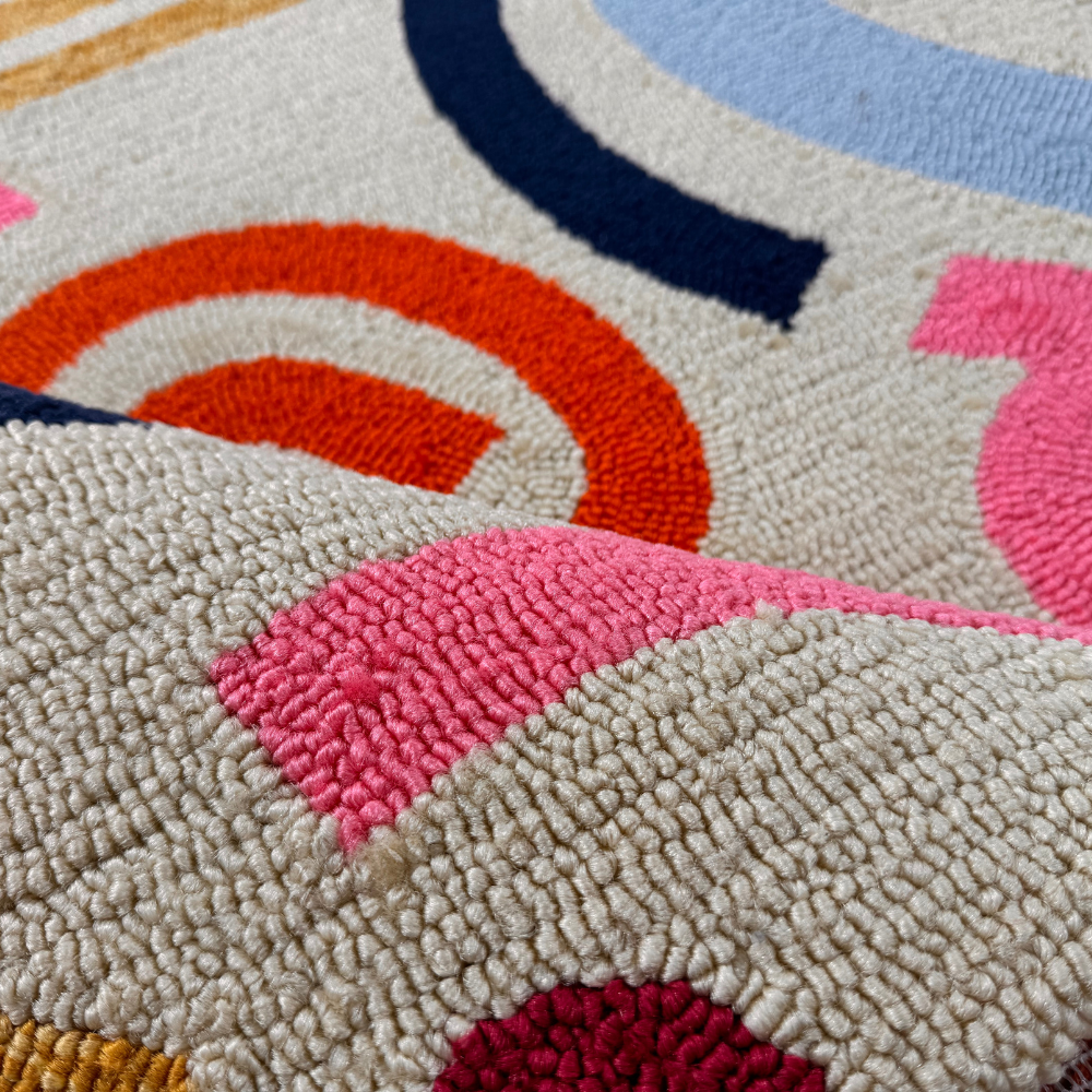 Close-up of Desert Sand rug highlighting vibrant abstract patterns and soft texture.